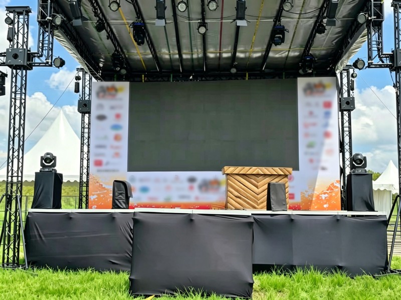 outdoor 8x8×6m lighting truss system installed on grass with slope roof